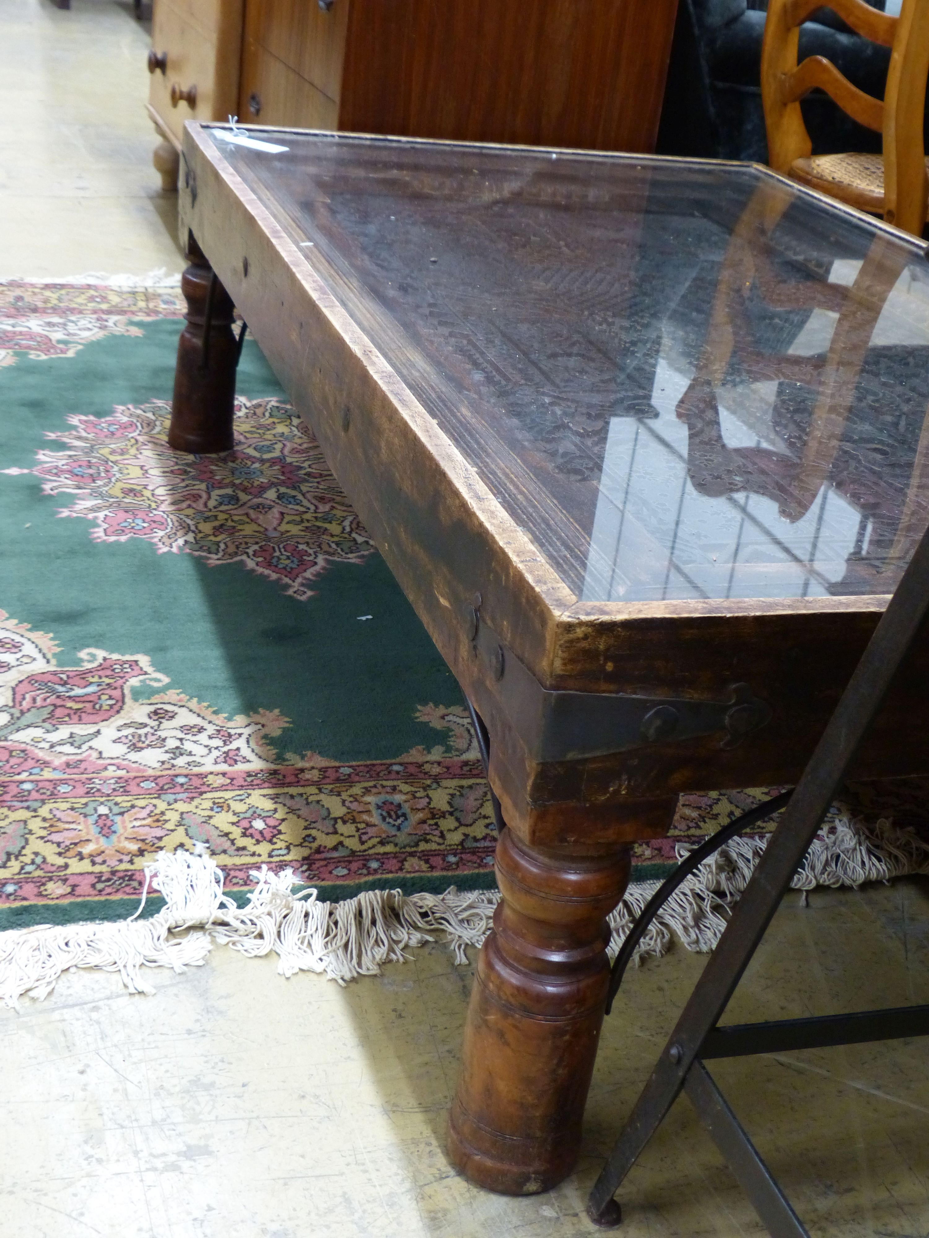 An Indian hardwood coffee table inset with a printing block, length 140cm, width 80cm